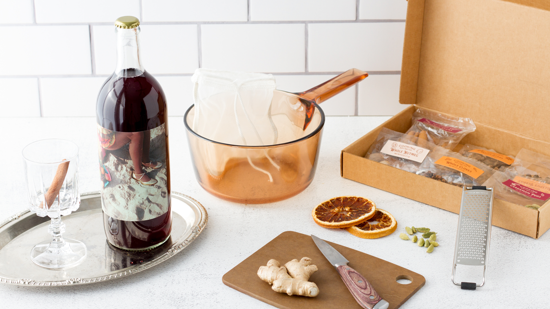 A bottle of Sangia red blend wine and a Mulled Wine kit on a white counter.