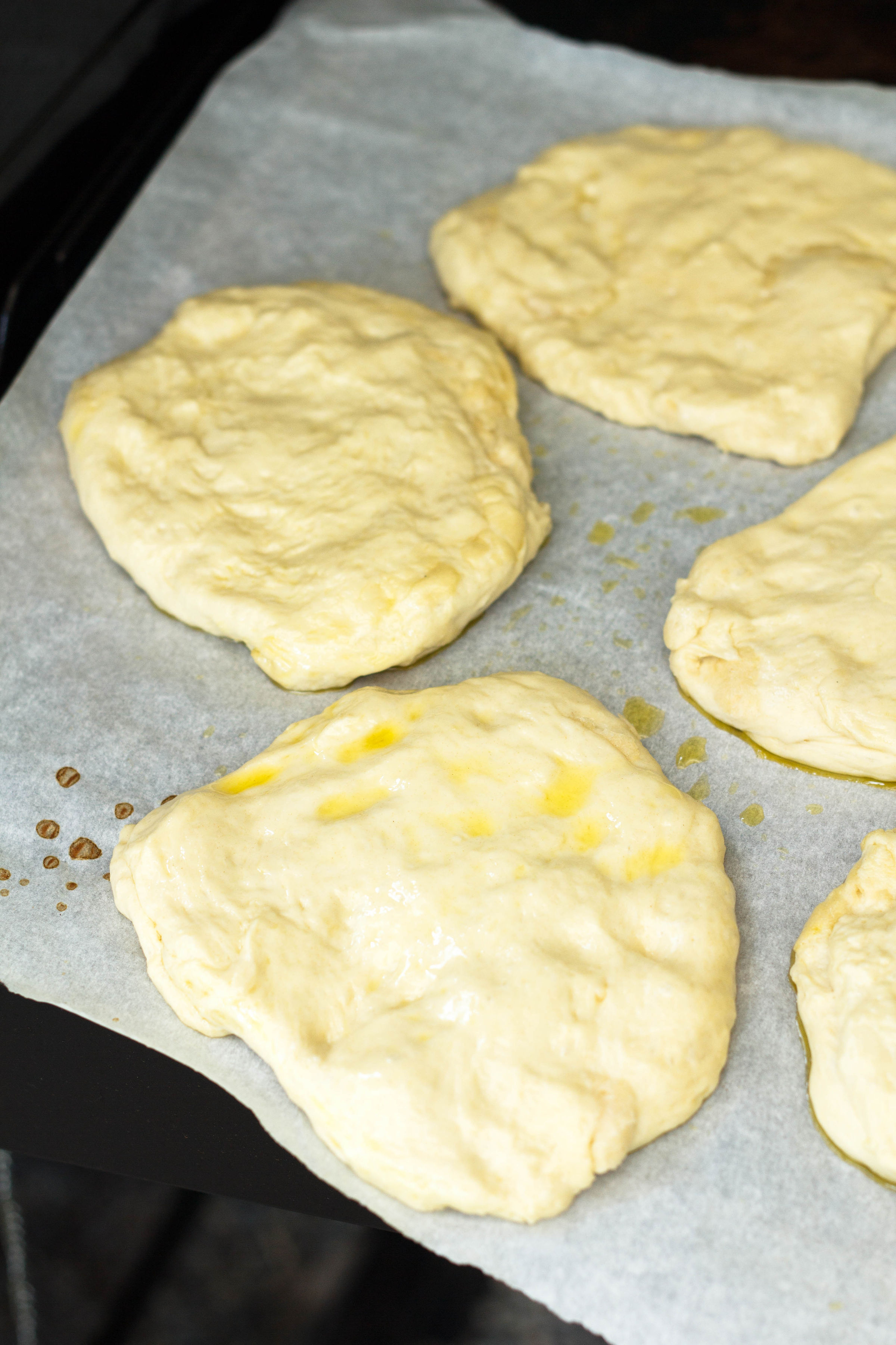 balls of flattened pizza dough