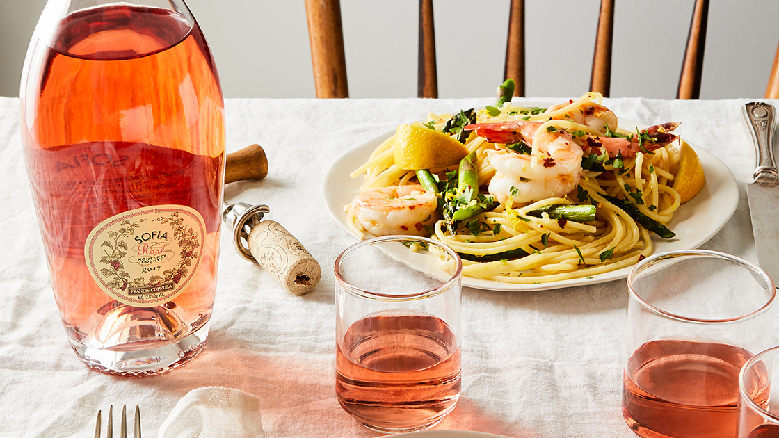 Sofia Rosé on a table with a shrimp pasta dish.