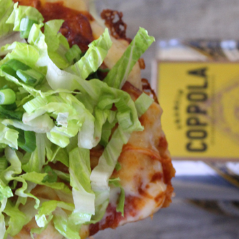 Close up of a salad on top of a pizza.