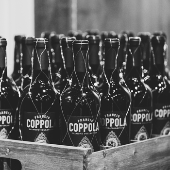 Close up of a crate of Coppola Claret wine bottles in black and white.
