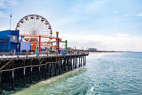 Santa Monica pier showing the ferris wheel , ocean and beach.