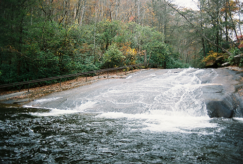Natural well-worn 60-foot waterslide from a smooth, flattened rock.